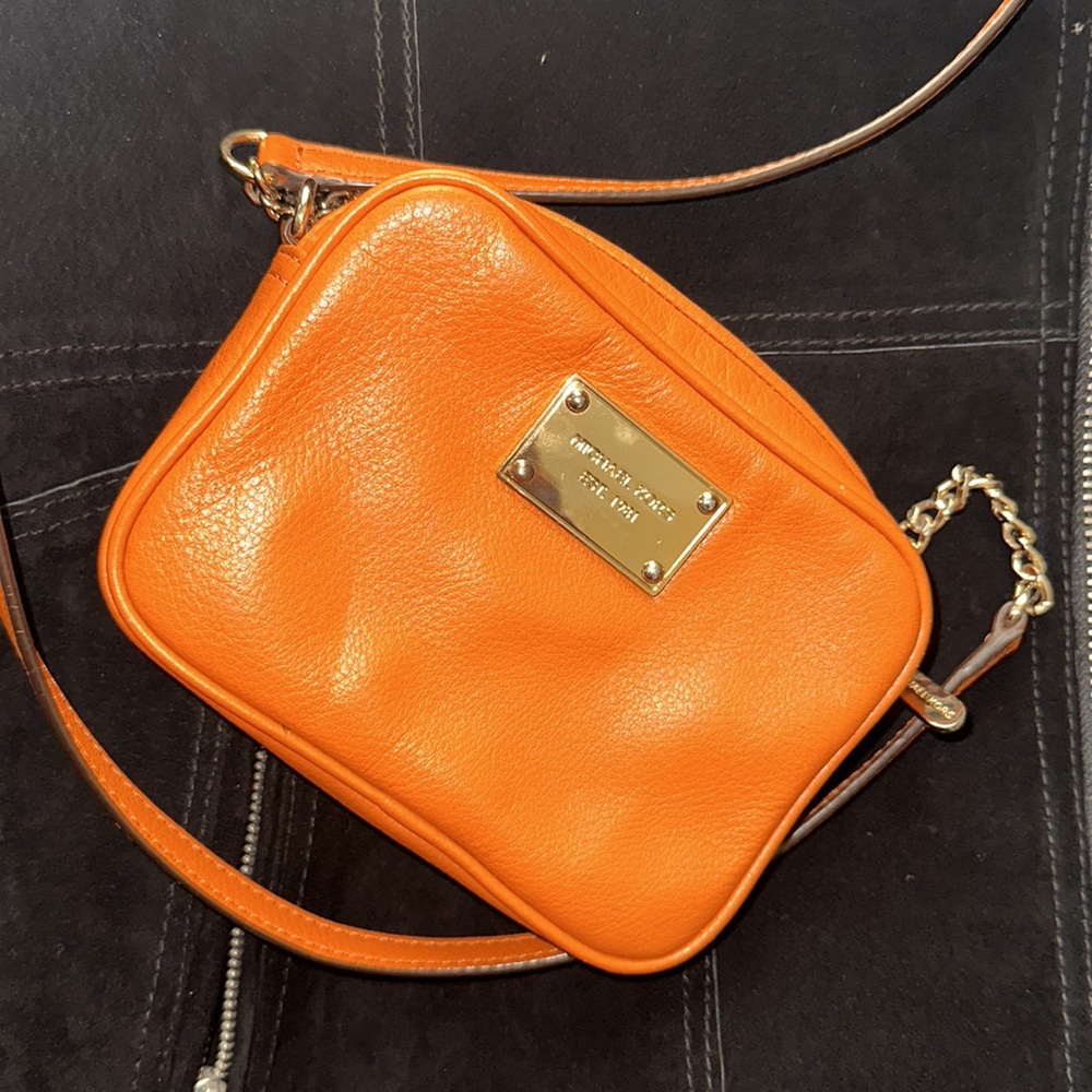Michael Kors cross body orange leather purse… gold hardware; very stylish.